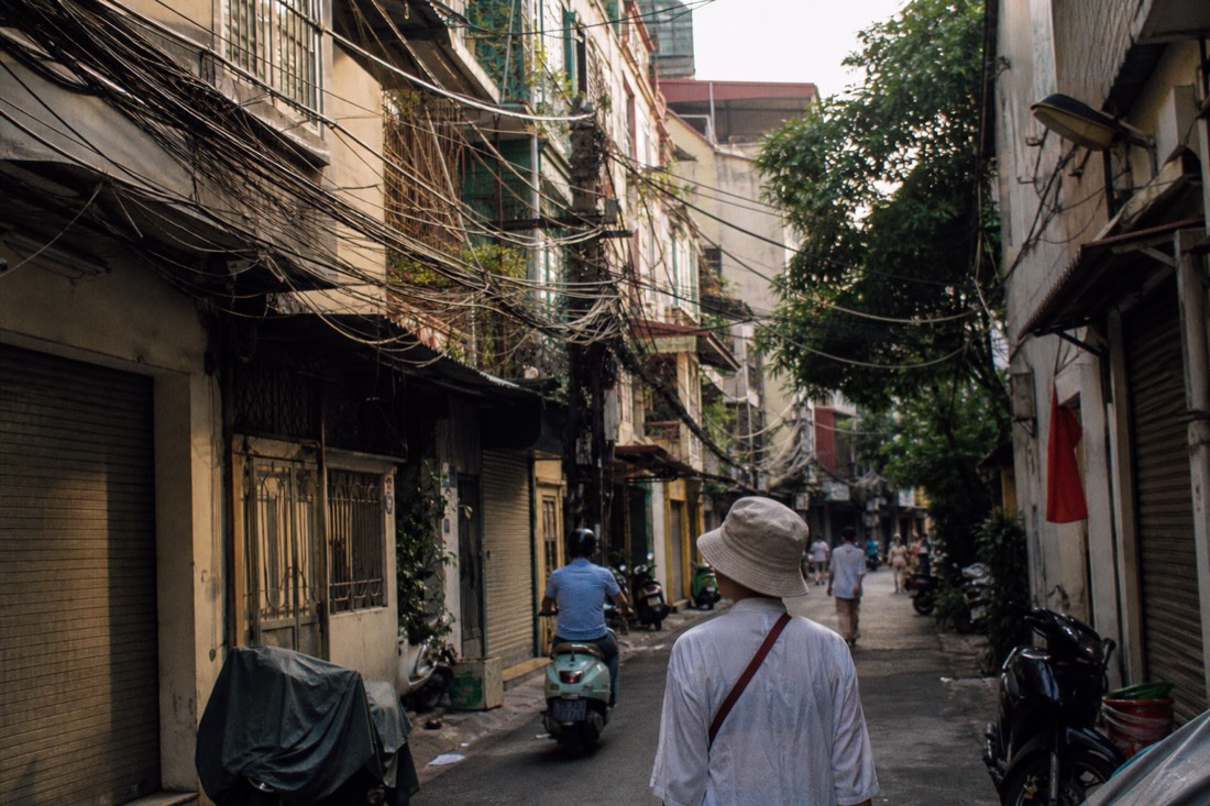 Narrow tube houses and Hang street signage above shopfronts in Hanoi's Old Quarter
