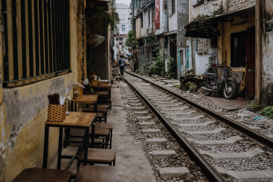 Track-side cafe tables set close to the railway corridor in Hanoi's Train Street