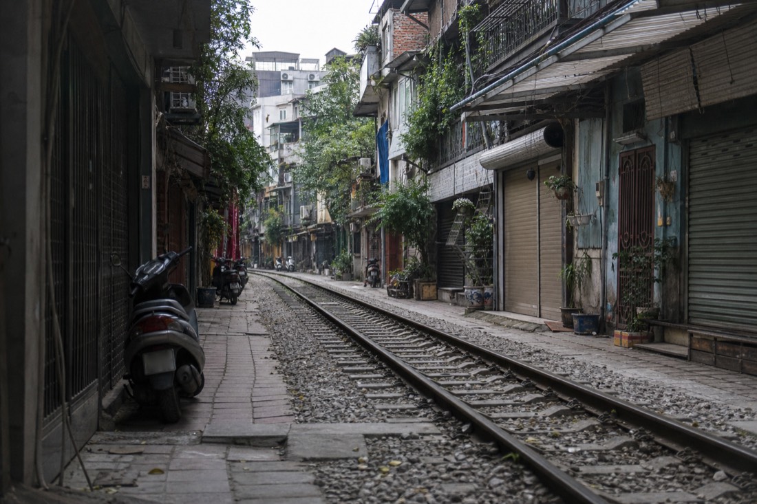 Quiet railway corridor lined with cafes and old houses in Hanoi's Train Street district