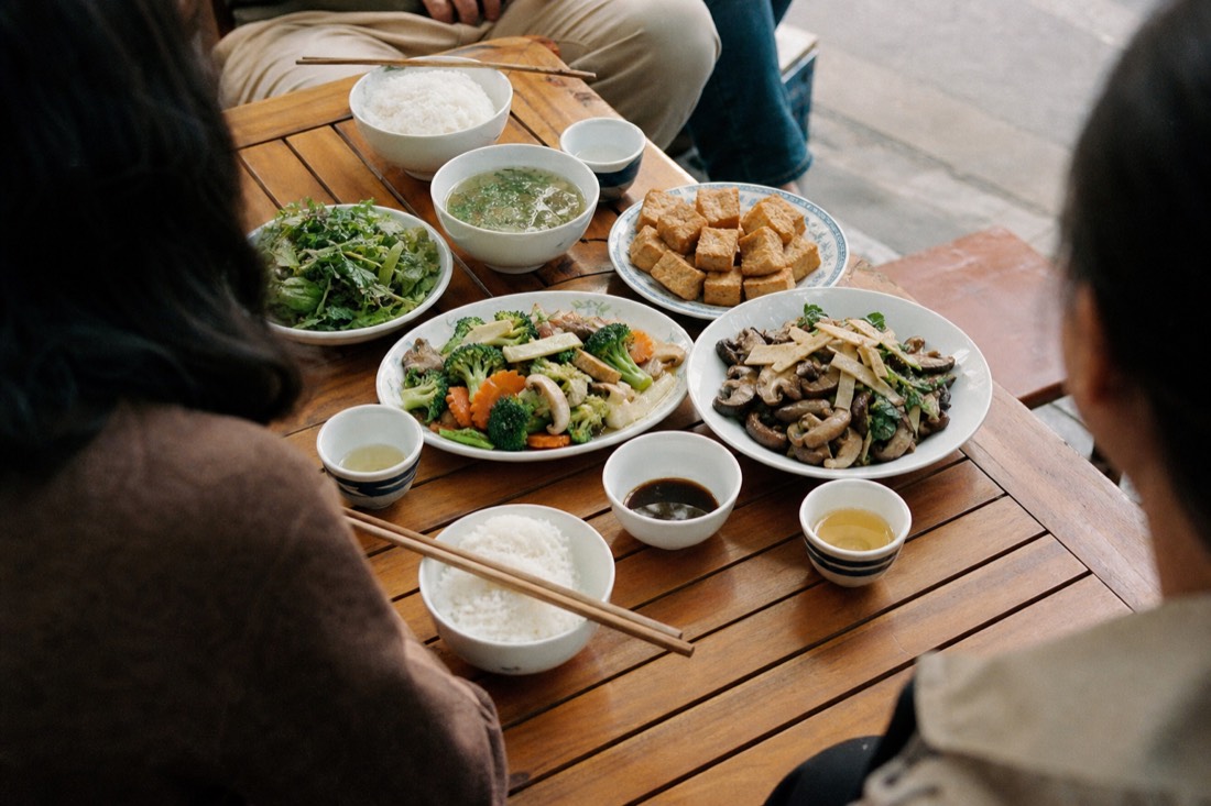 Table of vegetarian Vietnamese dishes with tofu, mushrooms and vegetables at a Hanoi eatery