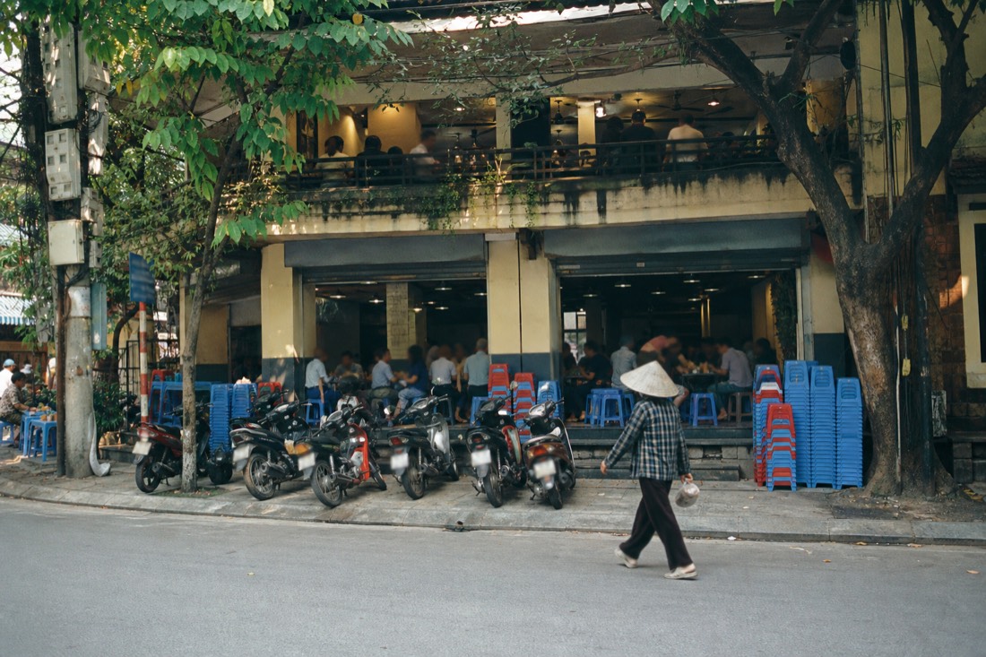 Multi-storey bun cha restaurant exterior in Hanoi's Hai Ba Trung district at lunchtime